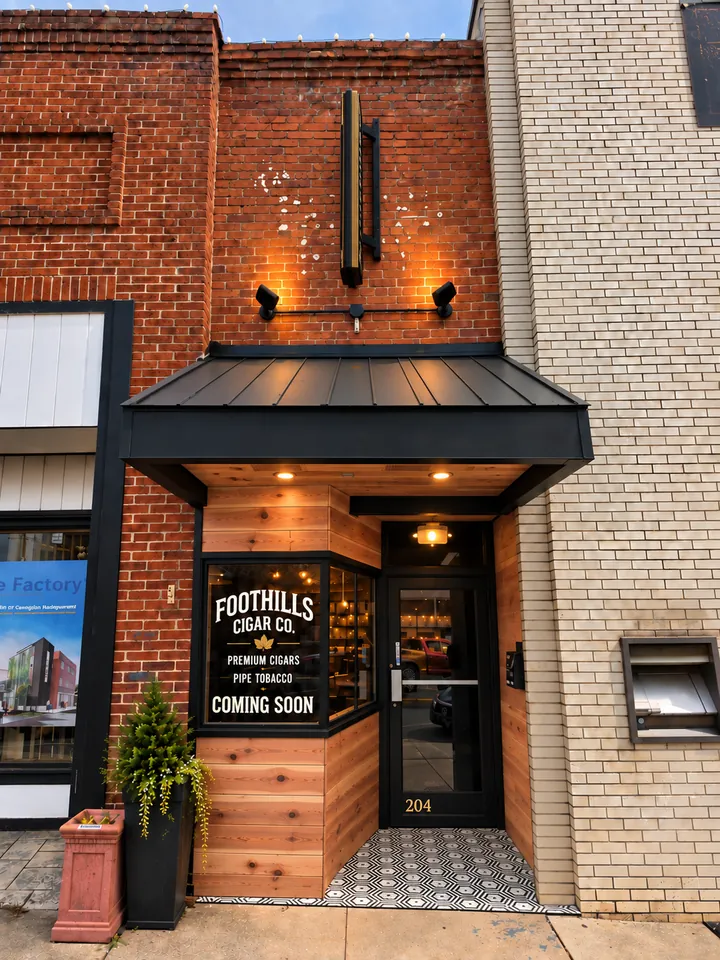 Planned Foothills Cigar Company storefront at 204 N. Main Street, with cedar entrance, black awning and window signage